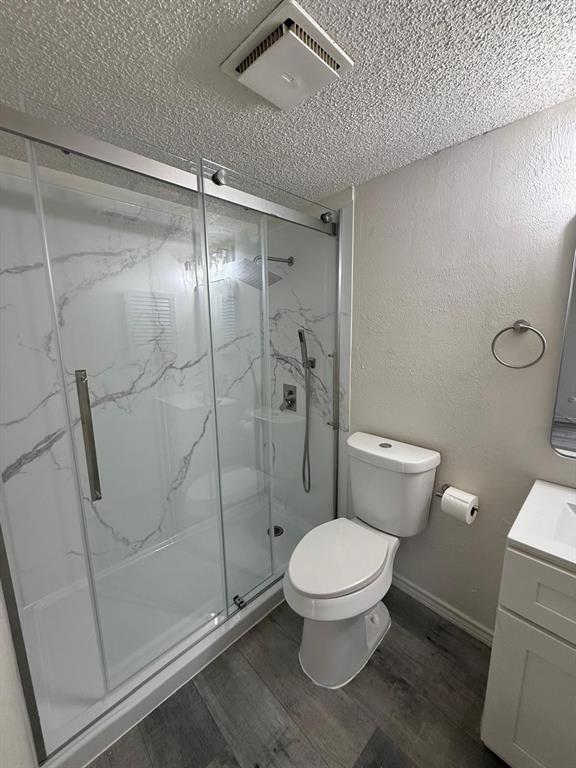 9807 Walnut Street, Unit D 304 Dallas, TX 75243 - Photo 7 of 7 a white toilet sitting next to a shower
