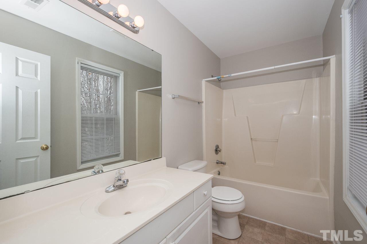 4424 Windstorm Way Raleigh, NC 27616 - Photo 12 of 14 a bathroom with a sink a toilet and shower