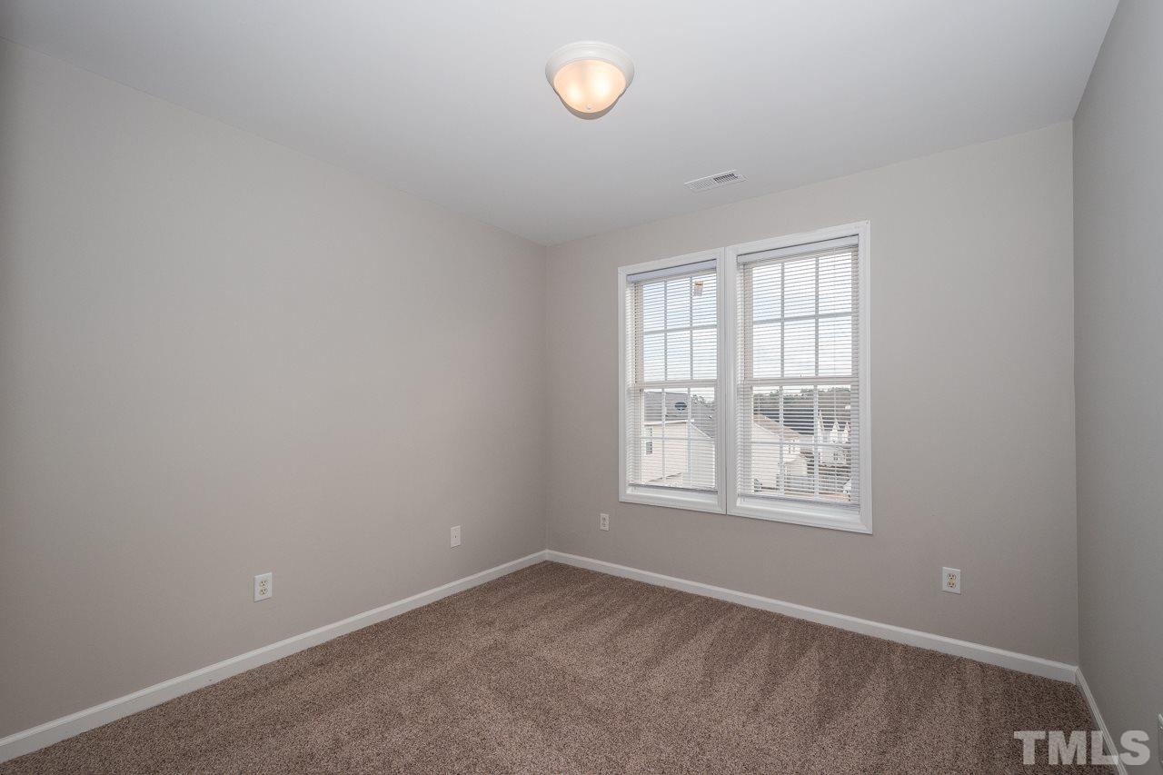 4424 Windstorm Way Raleigh, NC 27616 - Photo 13 of 14 an empty room with a window