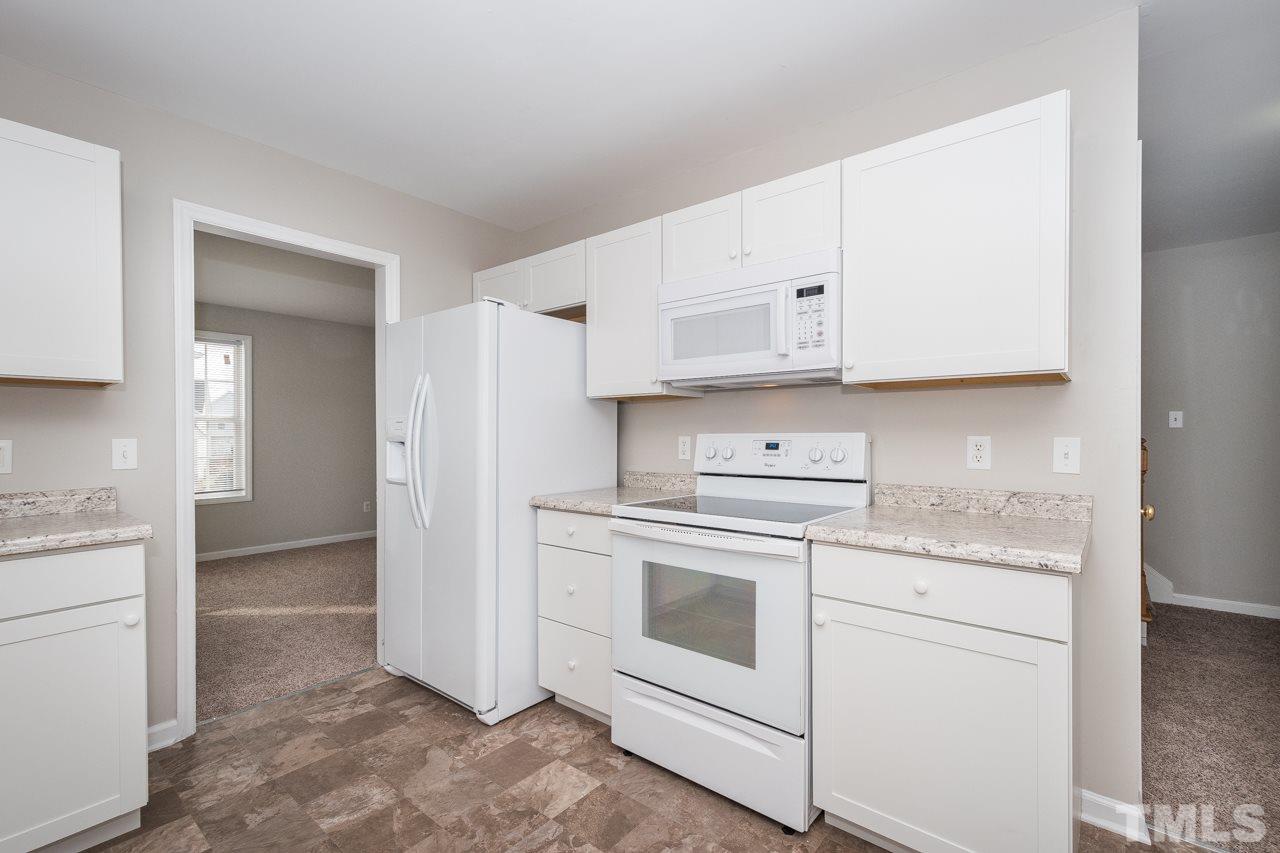 4424 Windstorm Way Raleigh, NC 27616 - Photo 4 of 14 a kitchen with cabinets appliances and a sink