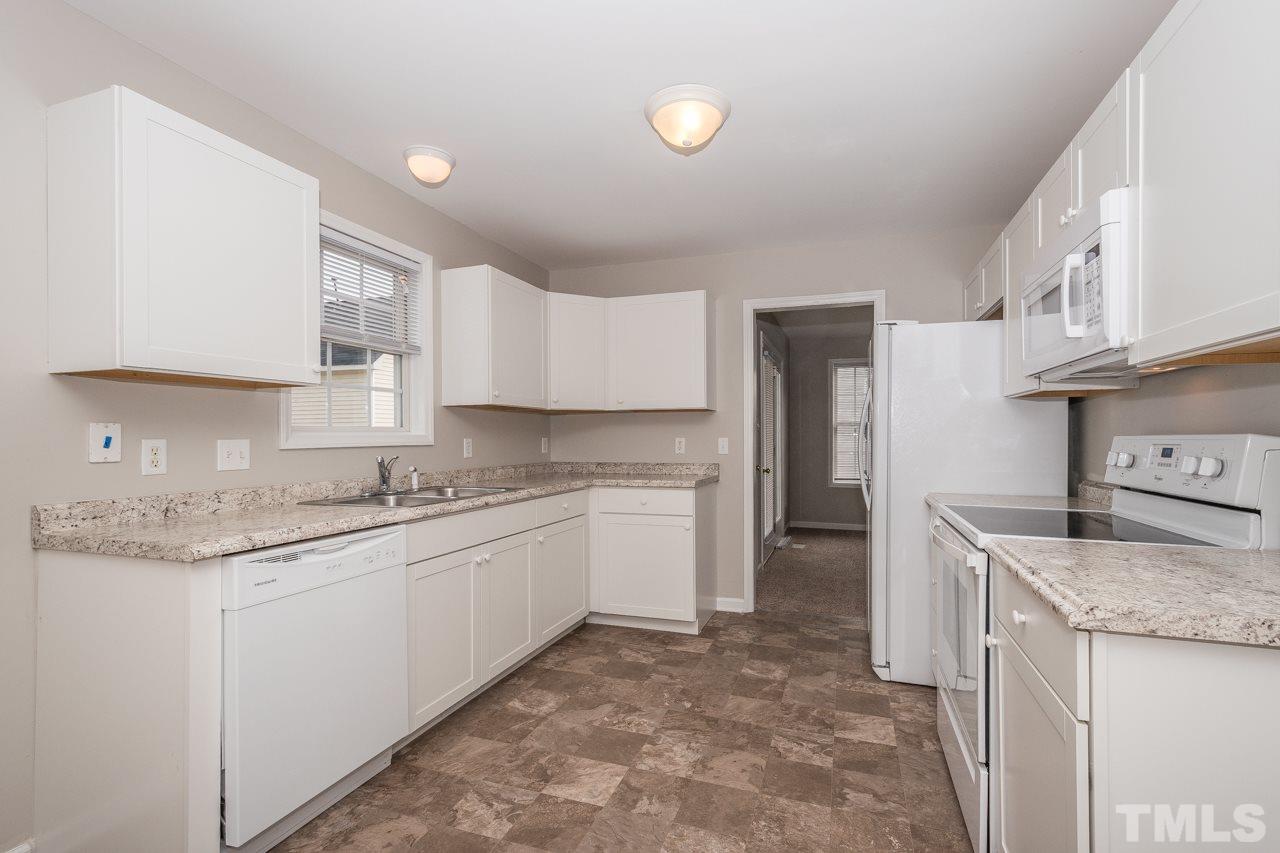 4424 Windstorm Way Raleigh, NC 27616 - Photo 5 of 14 a kitchen with a sink stove and cabinets