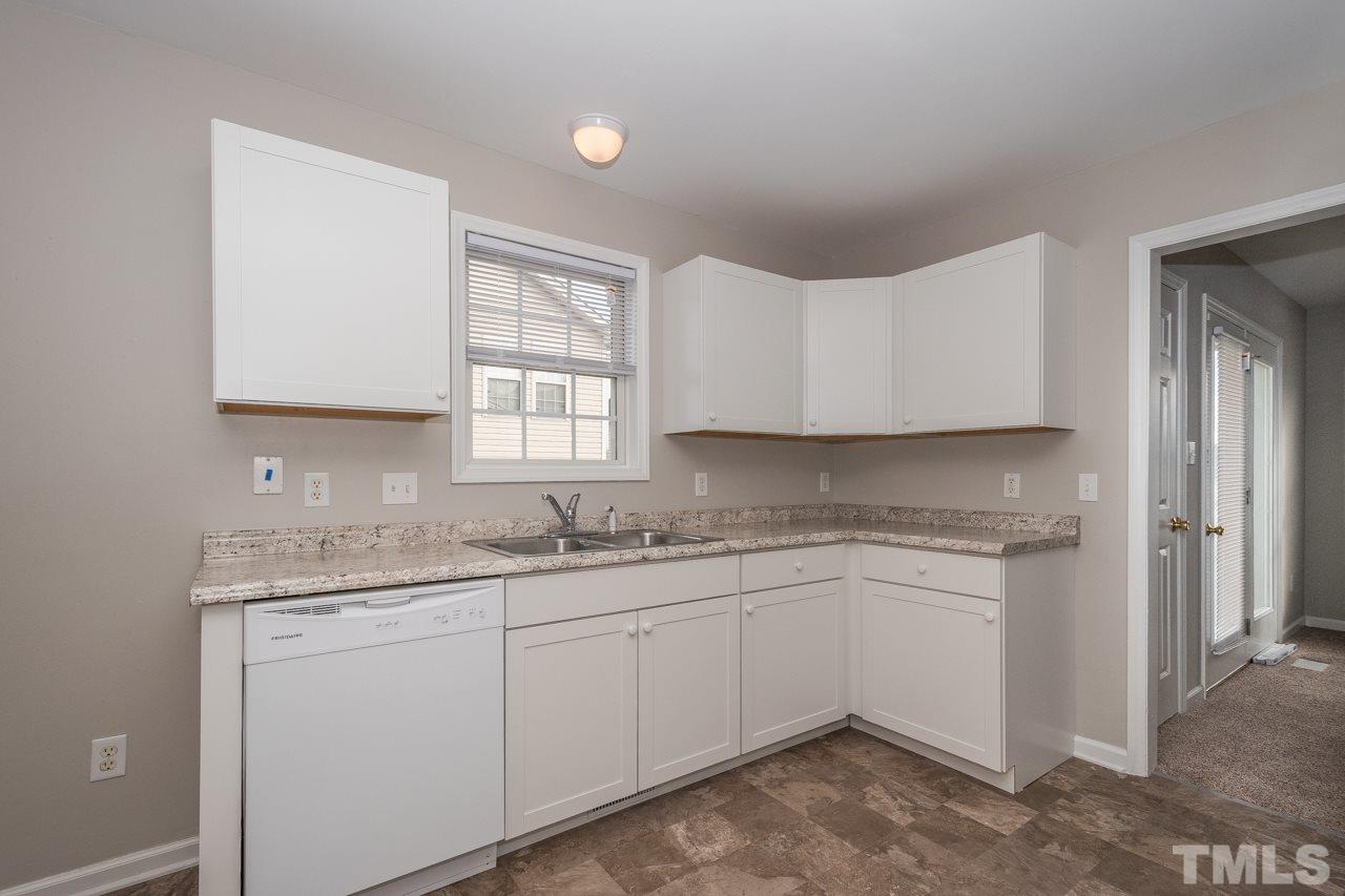 4424 Windstorm Way Raleigh, NC 27616 - Photo 6 of 14 a kitchen with a sink stove and cabinets