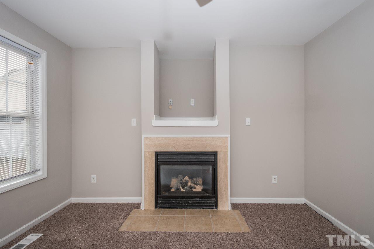 4424 Windstorm Way Raleigh, NC 27616 - Photo 9 of 14 a living room with furniture and a fireplace