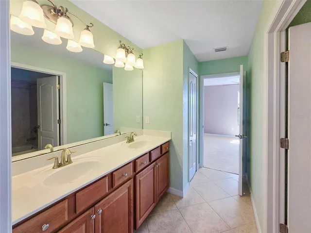 a view of a hallway with a ceiling fan