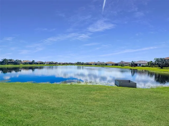a view of a swimming pool with outdoor seating and plants