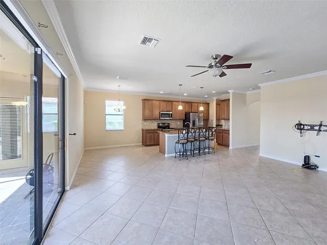 a view of a livingroom with furniture and a ceiling fan