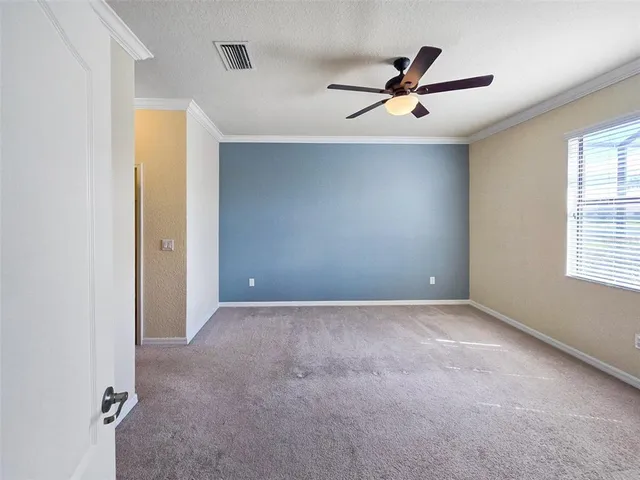 a view of a livingroom with a ceiling fan and window