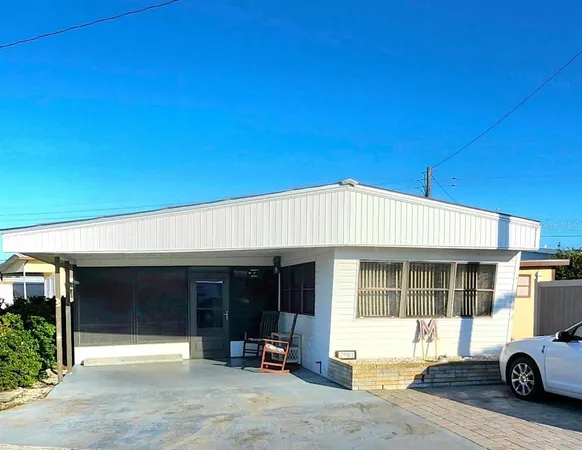 a car parked in front of white building