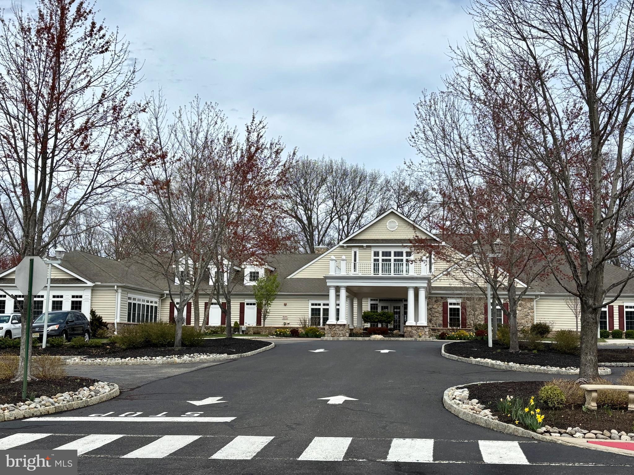 165 Einstein Way Cranbury, NJ 08512 - Photo 32 of 37 a front view of a building with lot of cars and trees