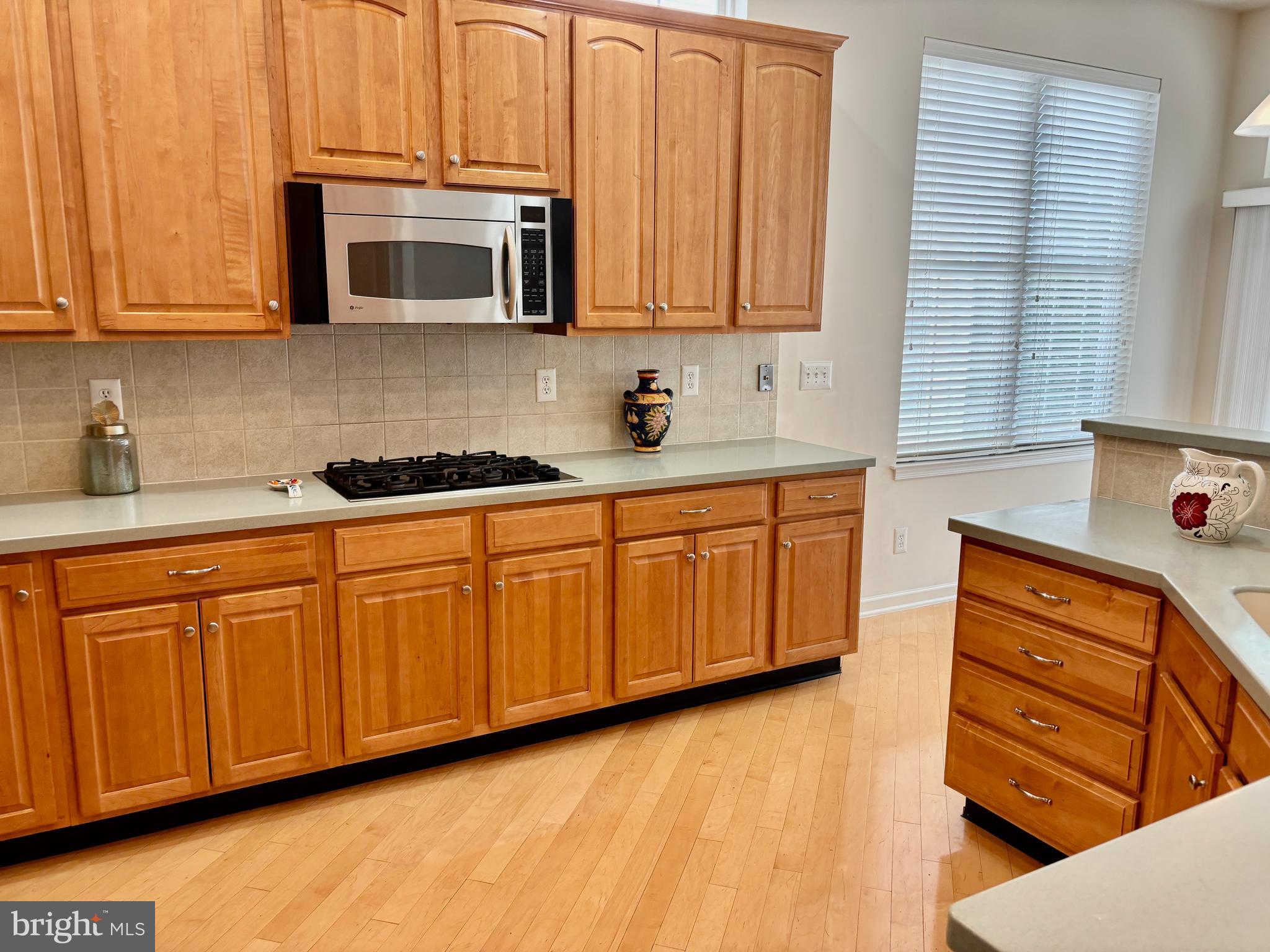 165 Einstein Way Cranbury, NJ 08512 - Photo 8 of 37 a kitchen with stainless steel appliances granite countertop wooden cabinets a stove a sink and dishwasher