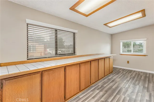 a view of a room with wooden floor and a window
