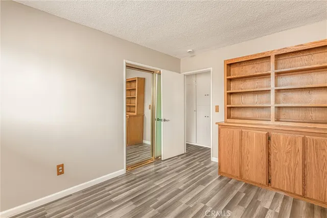 a view of a room with wooden floor and closet