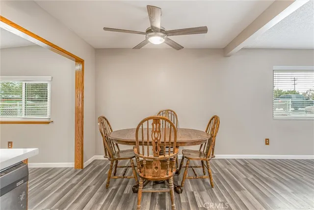 a view of a dining room with furniture and a window