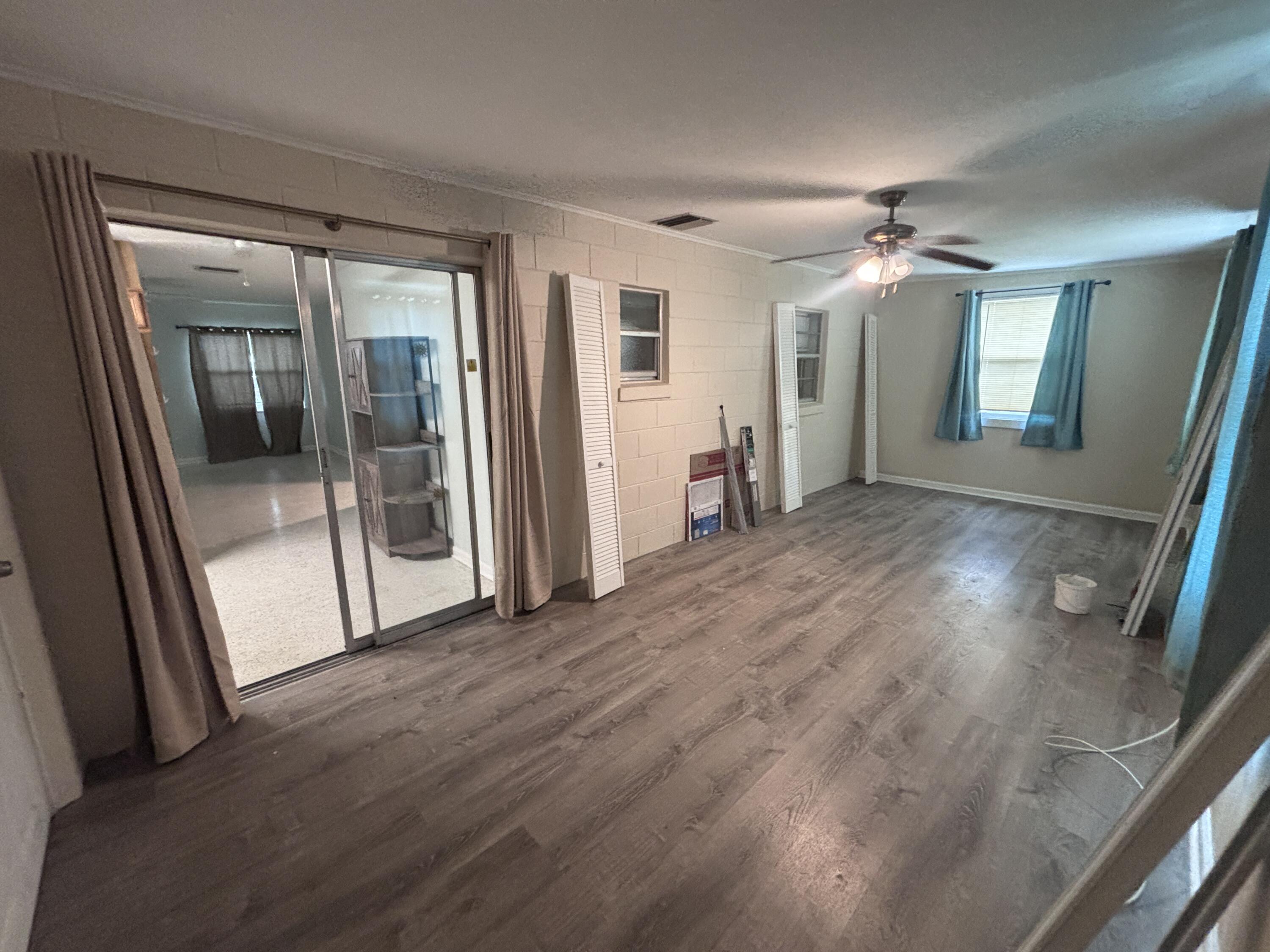 202 Balboa Street, Unit A Fort Pierce, FL 34949 - Photo 9 of 10 wooden floor in an empty room with a mirror