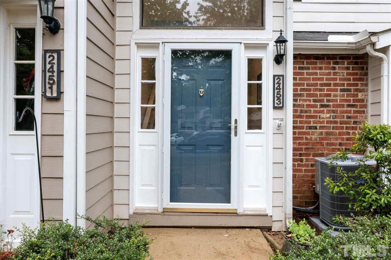 2453 Condor Court, Unit 2453 Raleigh, NC 27615 - Photo 2 of 26 front view of a brick house with large windows