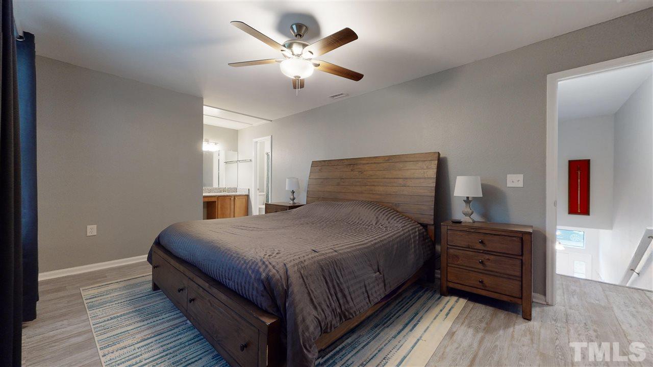 2453 Condor Court, Unit 2453 Raleigh, NC 27615 - Photo 16 of 26 a bedroom with a bed and wooden floor