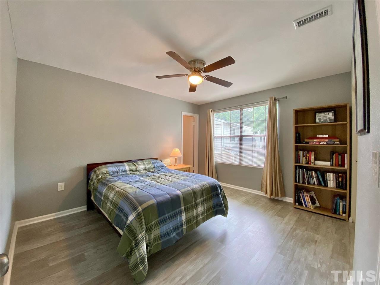 2453 Condor Court, Unit 2453 Raleigh, NC 27615 - Photo 18 of 26 a bedroom with a bed and a book shelf