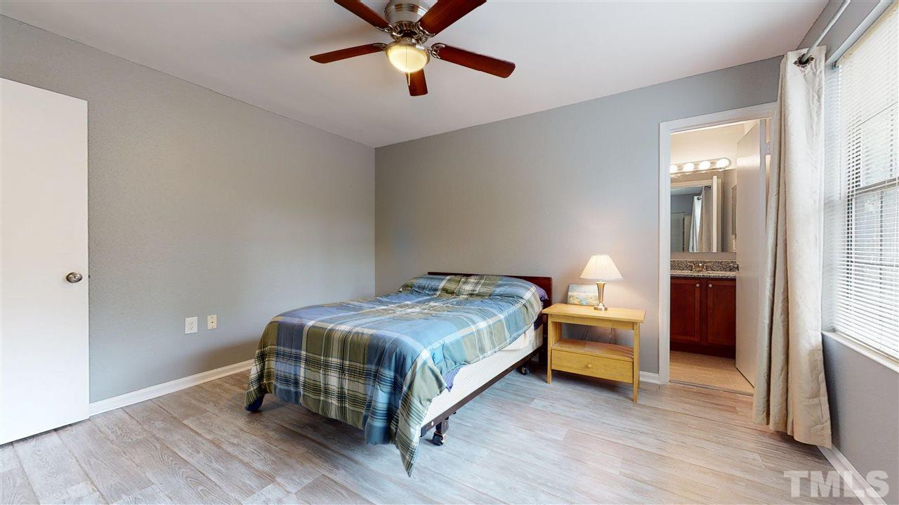 2453 Condor Court, Unit 2453 Raleigh, NC 27615 - Photo 19 of 26 a bedroom with a bed and a chandelier