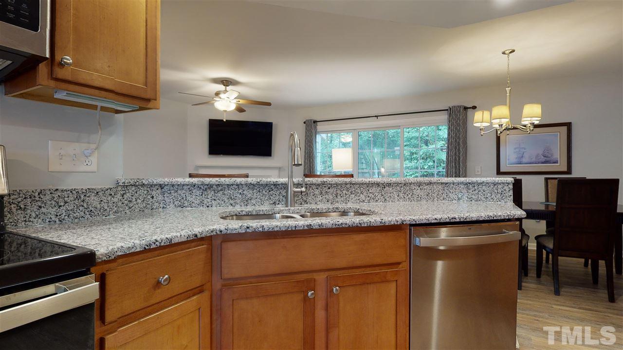 2453 Condor Court, Unit 2453 Raleigh, NC 27615 - Photo 6 of 26 a kitchen with stainless steel appliances granite countertop a sink stove and cabinets