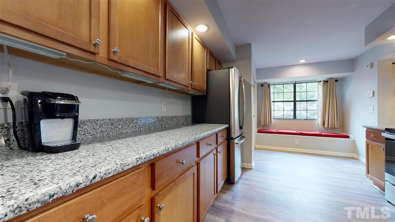 2453 Condor Court, Unit 2453 Raleigh, NC 27615 - Photo 9 of 26 a kitchen with stainless steel appliances granite countertop a sink and a granite counter tops