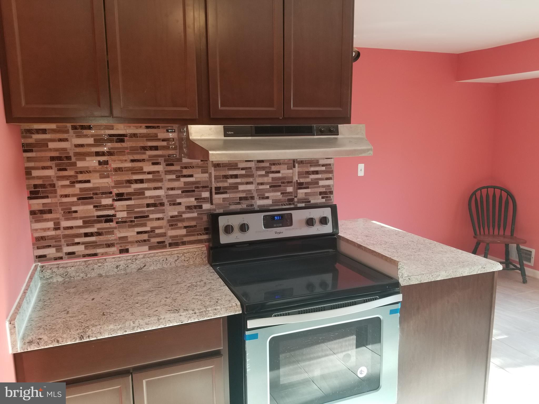 2708 Rambler Place Adelphi, MD 20783 - Photo 11 of 41 a kitchen with granite countertop a stove and a sink