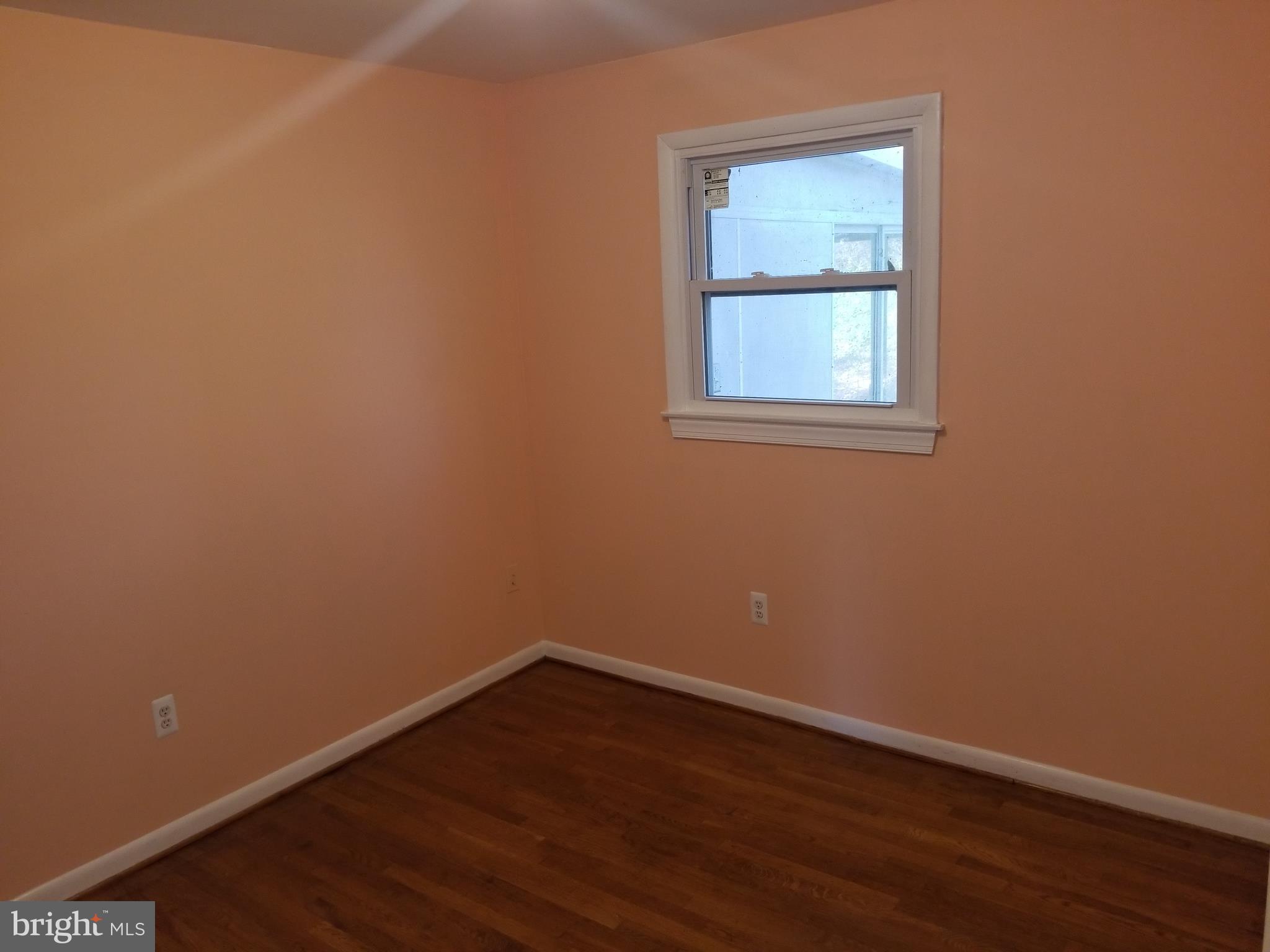 2708 Rambler Place Adelphi, MD 20783 - Photo 24 of 41 a view of an empty room with wooden floor and a window