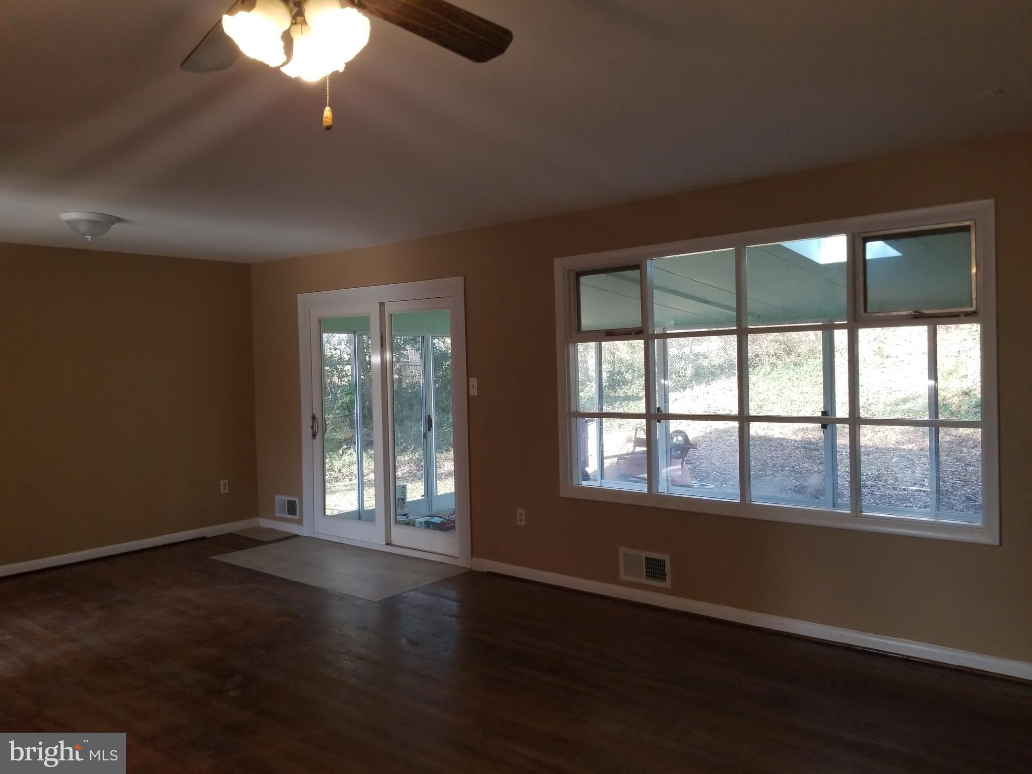 2708 Rambler Place Adelphi, MD 20783 - Photo 4 of 41 a view of an empty room with wooden floor and a window