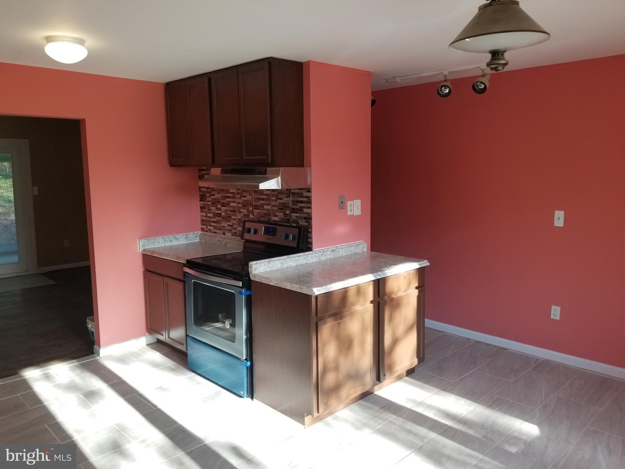 2708 Rambler Place Adelphi, MD 20783 - Photo 9 of 41 a kitchen with stainless steel appliances granite countertop a stove a refrigerator and a microwave
