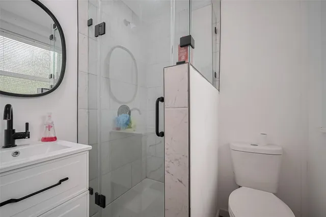 a bathroom with a sink toilet and shower