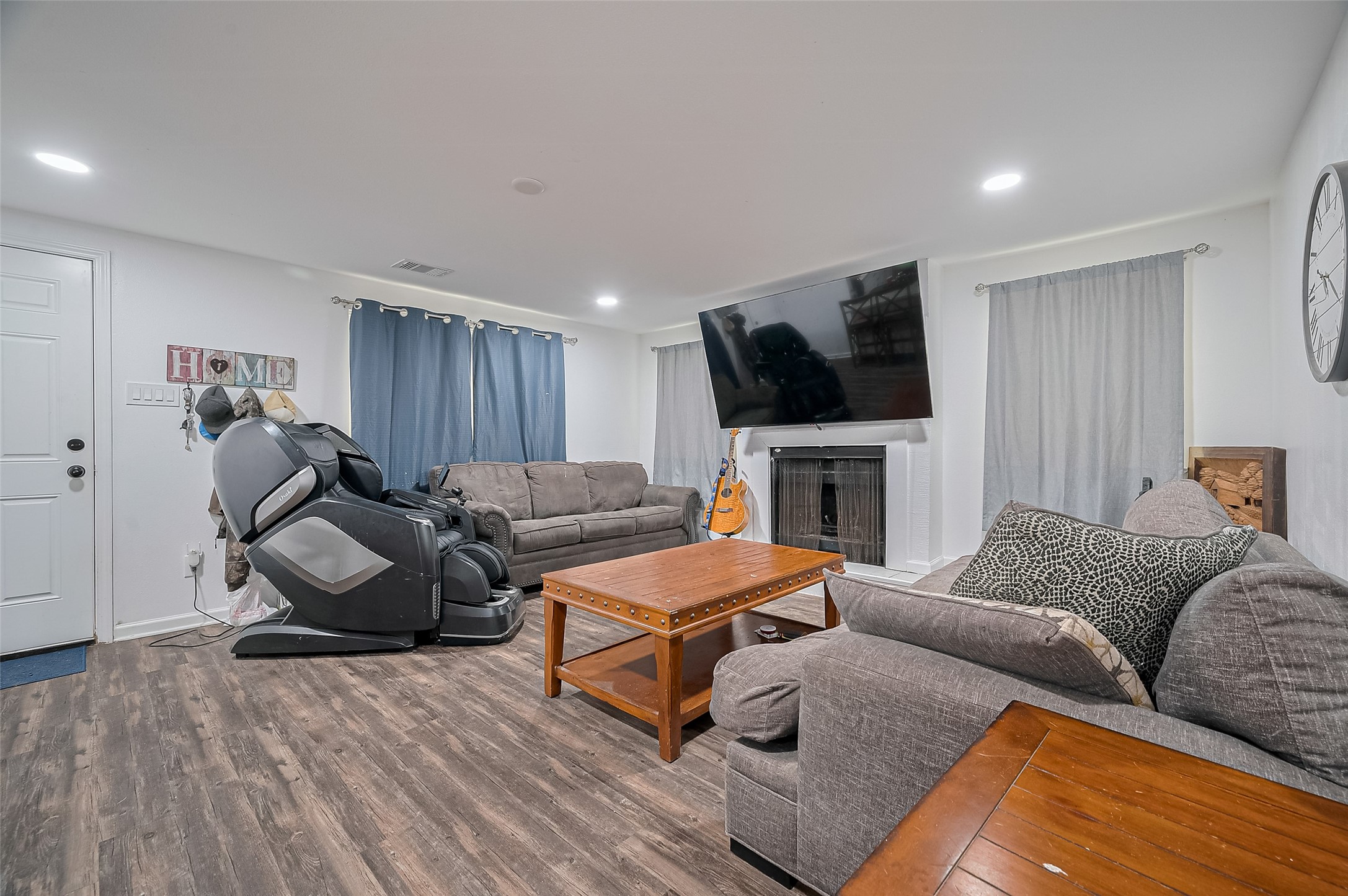 523 County Road 2073 Hull, TX 77564 - Photo 2 of 13 a living room with furniture a flat screen tv and a fireplace