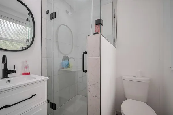 a bathroom with a sink toilet and shower