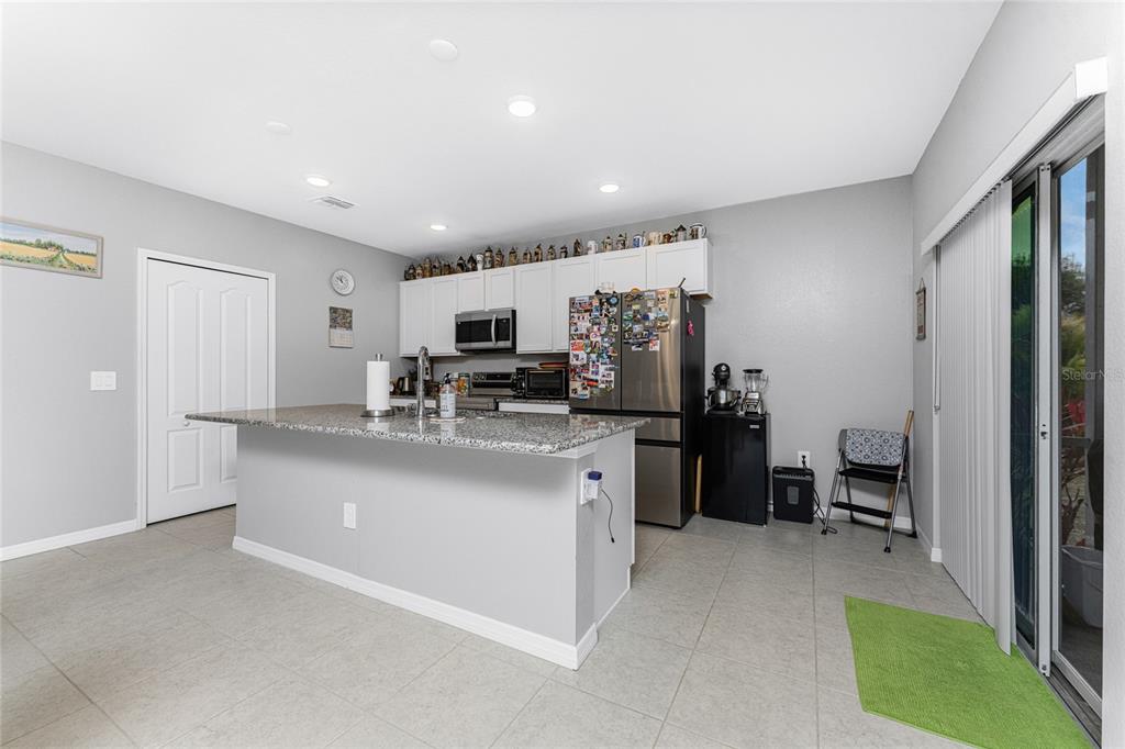 475 Posadas Circle Punta Gorda, FL 33983 - Photo 11 of 54 a kitchen with stainless steel appliances a sink a stove a refrigerator cabinets and a dining table