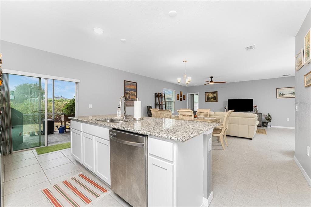 475 Posadas Circle Punta Gorda, FL 33983 - Photo 14 of 54 a kitchen with a sink and living room