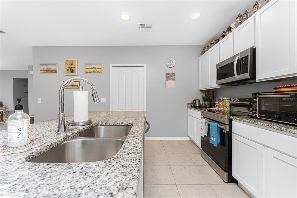 475 Posadas Circle Punta Gorda, FL 33983 - Photo 15 of 54 a kitchen with stainless steel appliances granite countertop a sink and a microwave