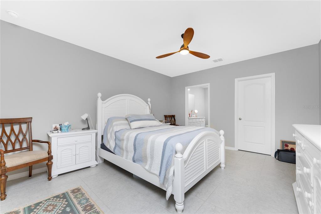 475 Posadas Circle Punta Gorda, FL 33983 - Photo 20 of 54 a bedroom with a bed and a chandelier