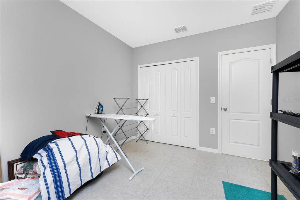 475 Posadas Circle Punta Gorda, FL 33983 - Photo 26 of 54 a bedroom with a bed and a cabinet