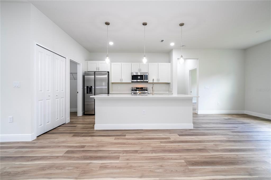 3998 Southwest 157th Place Road Ocala, FL 34473 - Photo 13 of 88 a view of kitchen with kitchen island stainless steel appliances cabinets a sink and a counter top space