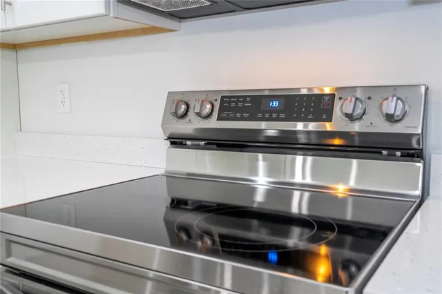 a view of a room that has wooden floor and window in it