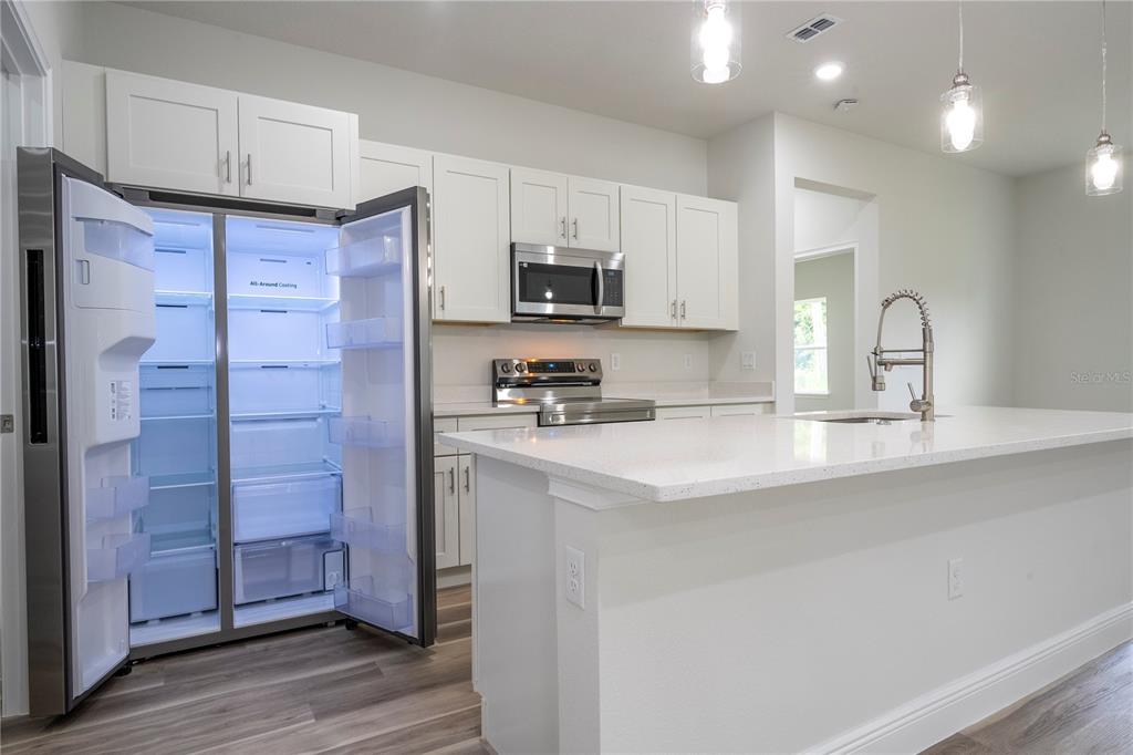 3998 Southwest 157th Place Road Ocala, FL 34473 - Photo 26 of 88 a kitchen with stainless steel appliances a refrigerator sink and microwave