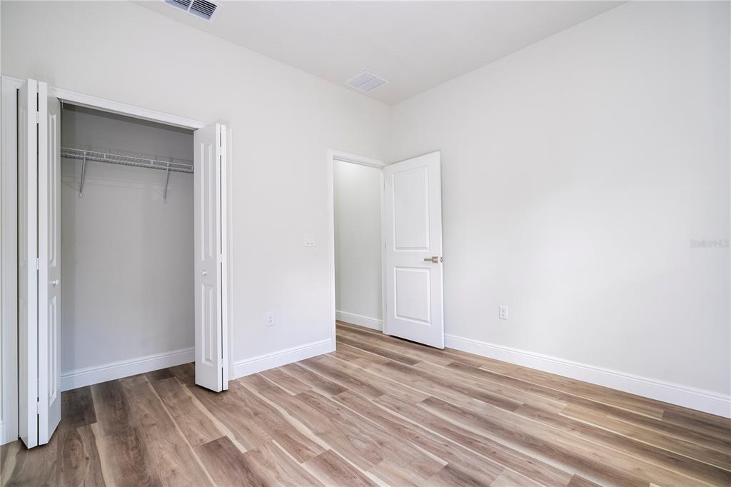 3998 Southwest 157th Place Road Ocala, FL 34473 - Photo 42 of 88 a view of an empty room with wooden floor and closet