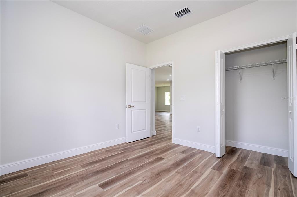 3998 Southwest 157th Place Road Ocala, FL 34473 - Photo 53 of 88 a view of an empty room with wooden floor and closet