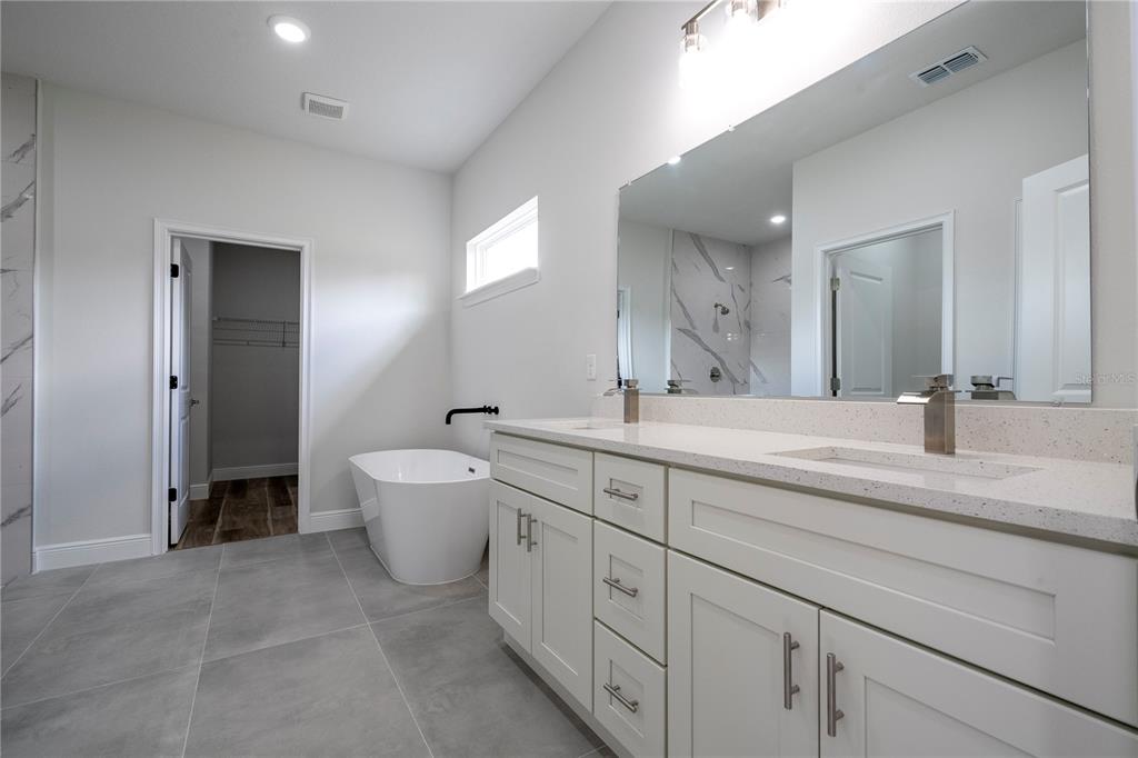 3998 Southwest 157th Place Road Ocala, FL 34473 - Photo 67 of 88 a spacious bathroom with a double vanity sink mirror and toilet