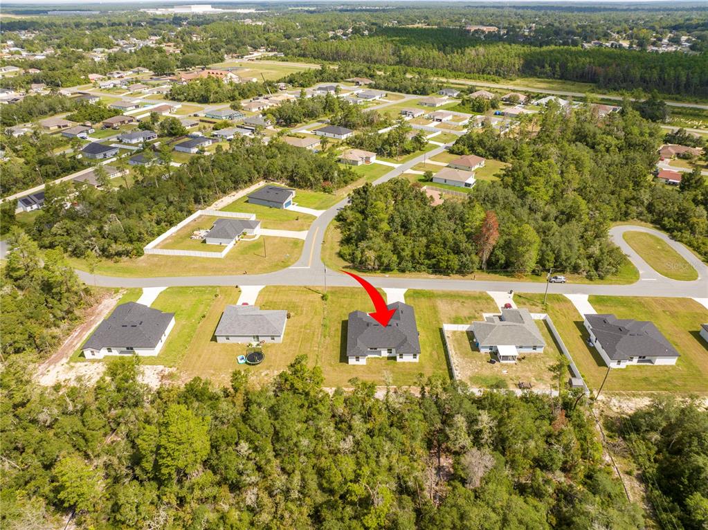3998 Southwest 157th Place Road Ocala, FL 34473 - Photo 77 of 88 an aerial view of residential houses with outdoor space and swimming pool
