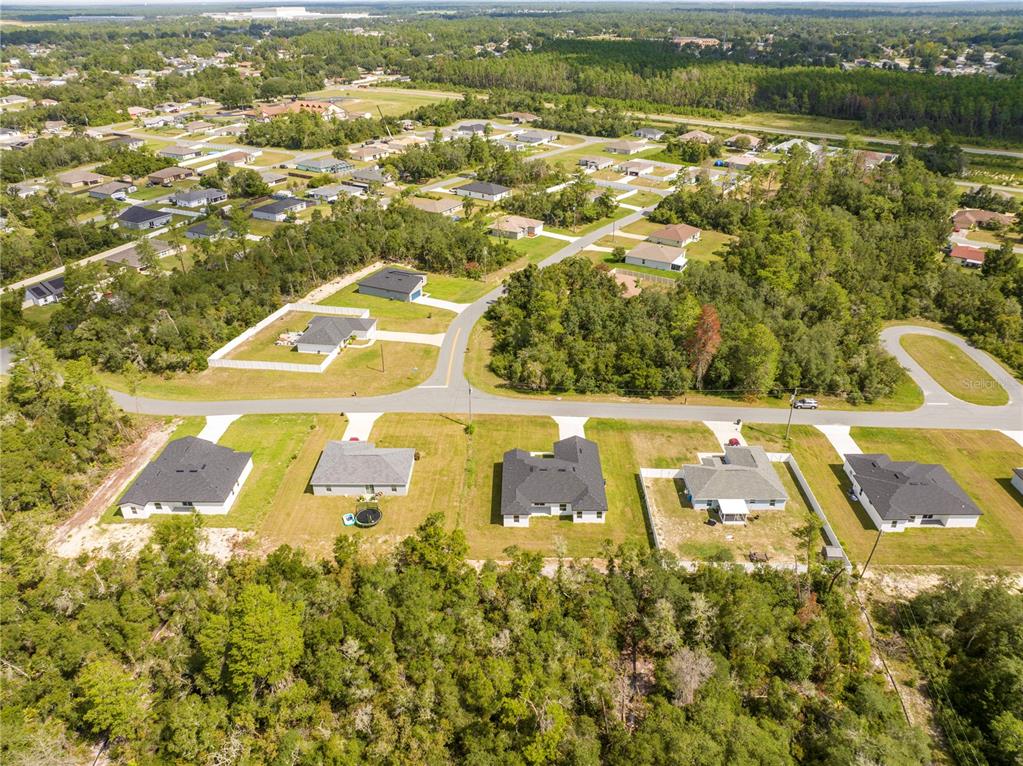 3998 Southwest 157th Place Road Ocala, FL 34473 - Photo 78 of 88 an aerial view of residential houses with outdoor space and swimming pool