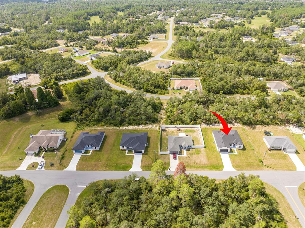 3998 Southwest 157th Place Road Ocala, FL 34473 - Photo 87 of 88 an aerial view of residential houses with outdoor space and swimming pool