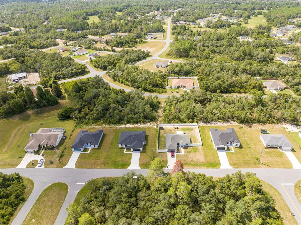 3998 Southwest 157th Place Road Ocala, FL 34473 - Photo 88 of 88 an aerial view of residential houses with outdoor space and parking