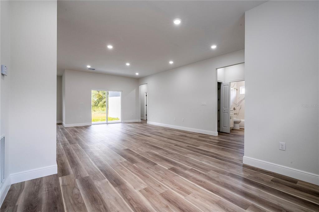 3998 Southwest 157th Place Road Ocala, FL 34473 - Photo 9 of 88 a view of an empty room with window and wooden floor