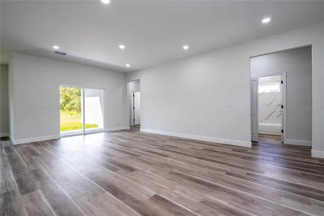 a large kitchen with a sink and a refrigerator