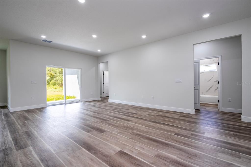 3998 Southwest 157th Place Road Ocala, FL 34473 - Photo 10 of 88 a view of empty room with wooden floor and fan
