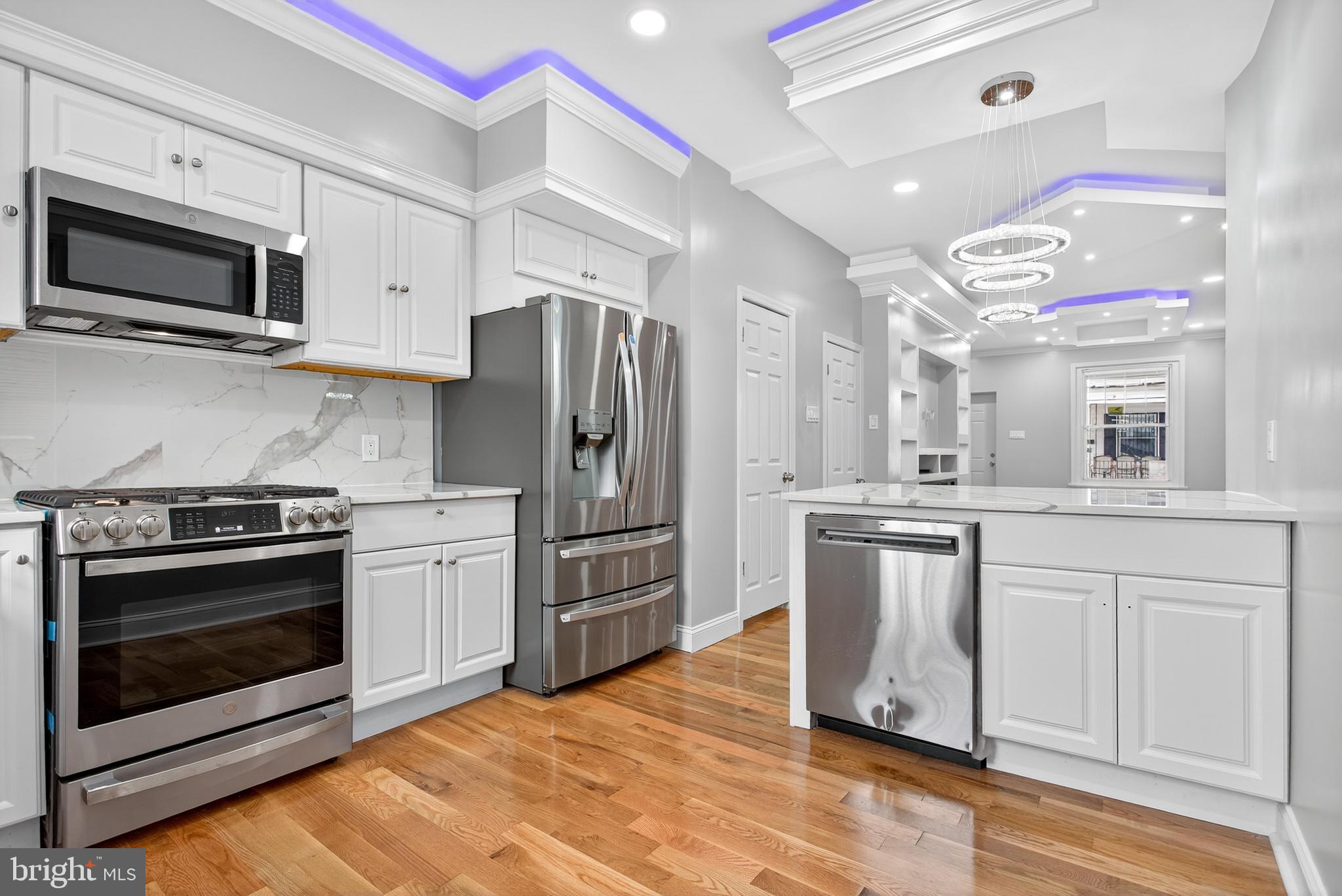6351 Reedland Street Philadelphia, PA 19142 - Photo 13 of 30 a kitchen with stainless steel appliances a stove a sink and a microwave